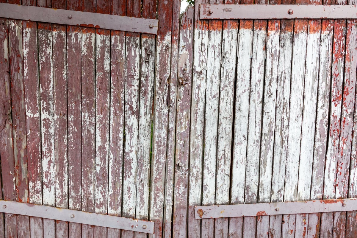 Weathered broken fence before restoration